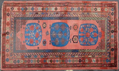 Lot 1059 - A Khotan long red ground rug