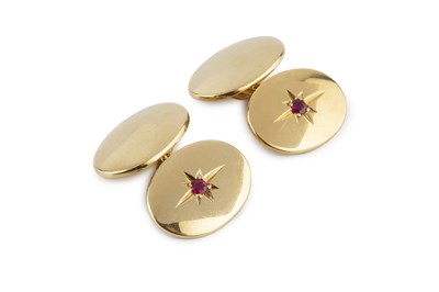 Lot 59 - A pair of ruby set cufflinks, with oval panels...