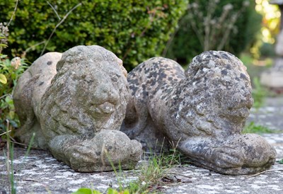 Lot 1234 - A pair of cast reconstituted stone recumbent lions