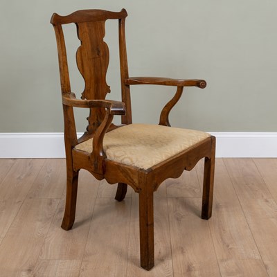 Lot 200 - An early 19th century walnut elbow chair with...