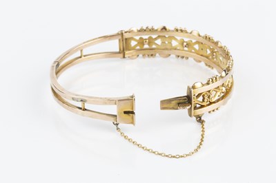 Lot 107 - An Edwardian 9ct gold bangle by Smith & Pepper,...