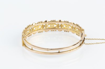 Lot 107 - An Edwardian 9ct gold bangle by Smith & Pepper,...