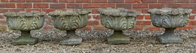 Lot 1189 - A set of four cast reconstituted stone acanthus leaf moulded garden urns