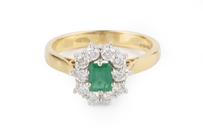 Lot 142 - An emerald and diamond cluster ring, the...