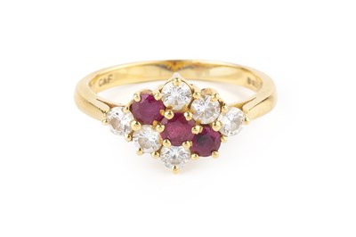 Lot 140 - A ruby and diamond cluster ring, the...