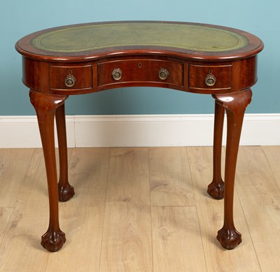 Lot 228 - A mahogany kidney shaped writing table with...