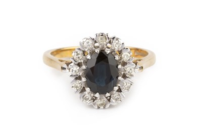 Lot 125 - A sapphire and diamond cluster ring, the oval...