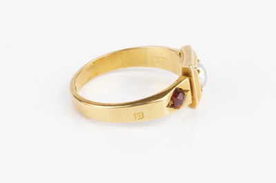 Lot 33 - A garnet and half pearl dress ring, centred...