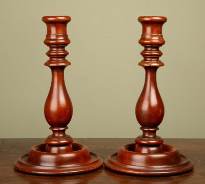 Lot 222 - A pair of turned wooden candle sticks in the...