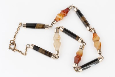 Lot 47 - A banded agate necklace, comprising a line of...