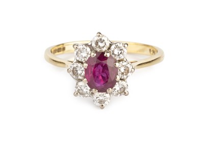 Lot 141 - A ruby and diamond cluster ring, the oval...