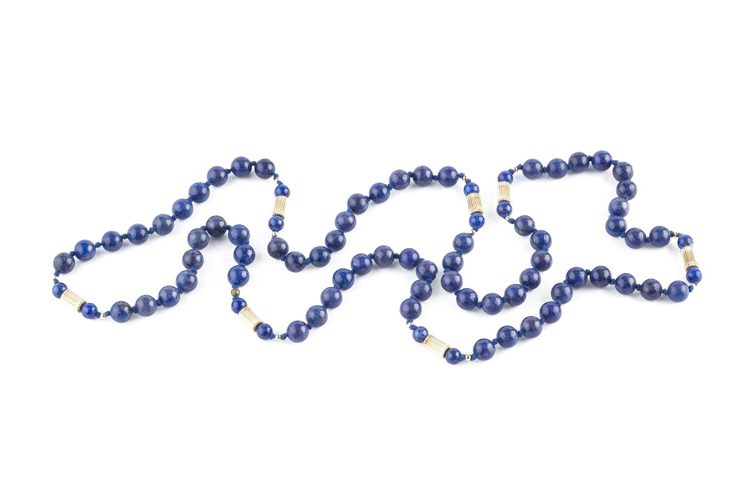 Lot 228 - A lapis lazuli bead necklace, of continuous...