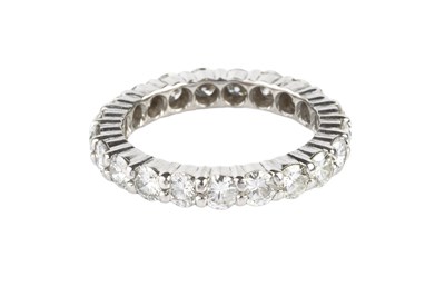 Lot 182 - A diamond full hoop ring, claw set throughout...