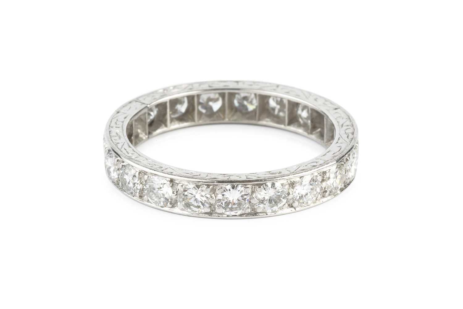 Lot 117 - A diamond full hoop ring, grain set throughout...