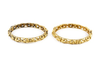 Lot 5 - A pair of yellow precious metal bangles, of...