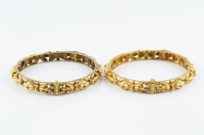 Lot 5 - A pair of yellow precious metal bangles, of...
