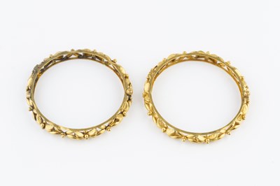 Lot 5 - A pair of yellow precious metal bangles, of...
