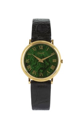 Lot 212 - A wristwatch by Piaget, the circular green...