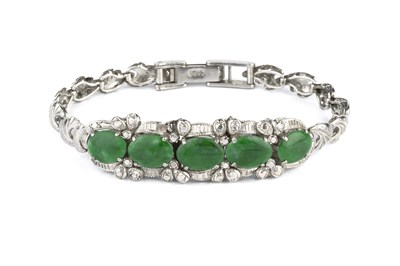 Lot 80 - A jade bracelet, the convex articulated...