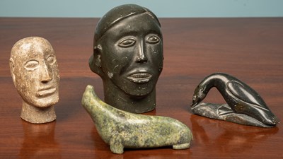 Lot 234 - Four Inuit soapstone carvings, two heads, a...