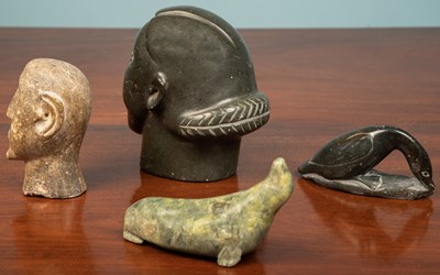 Lot 234 - Four Inuit soapstone carvings, two heads, a...