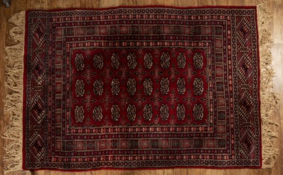 Lot 117 - Red ground rug Pakistan, with a panel of...