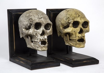 Lot 125 - A pair of book ends of skull form, 14cm wide x...
