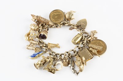 Lot 24 - A charm bracelet, the 9ct gold curb-link...