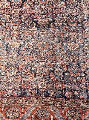 Lot 1047 - A large Persian rug