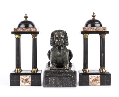 Lot 119 - An Antique bronze sphinx on a hardstone base,...