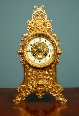 Lot 114 - An ornate French gilt metal clock, with an...