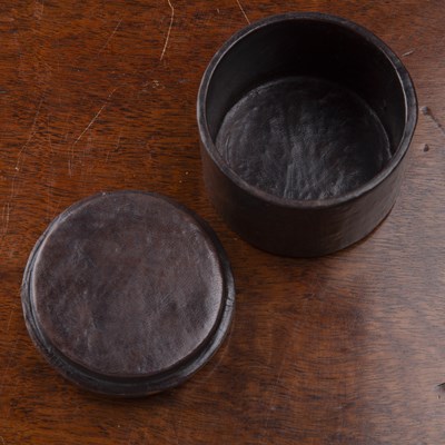 Lot 203 - Small leather cylindrical box with impressed...