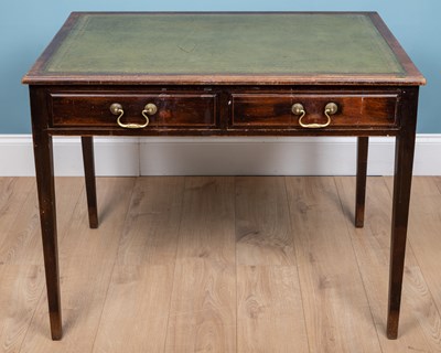 Lot 310 - A leather topped writing desk with two drawers...