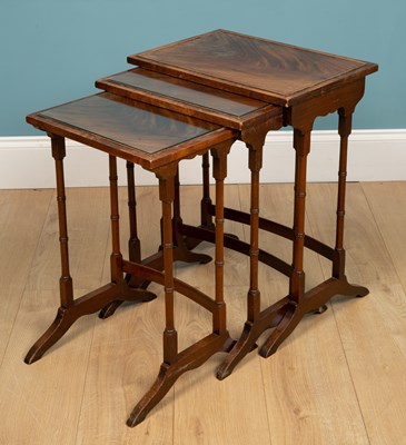 Lot 303 - A nest of three tables, mahogany, with carved...