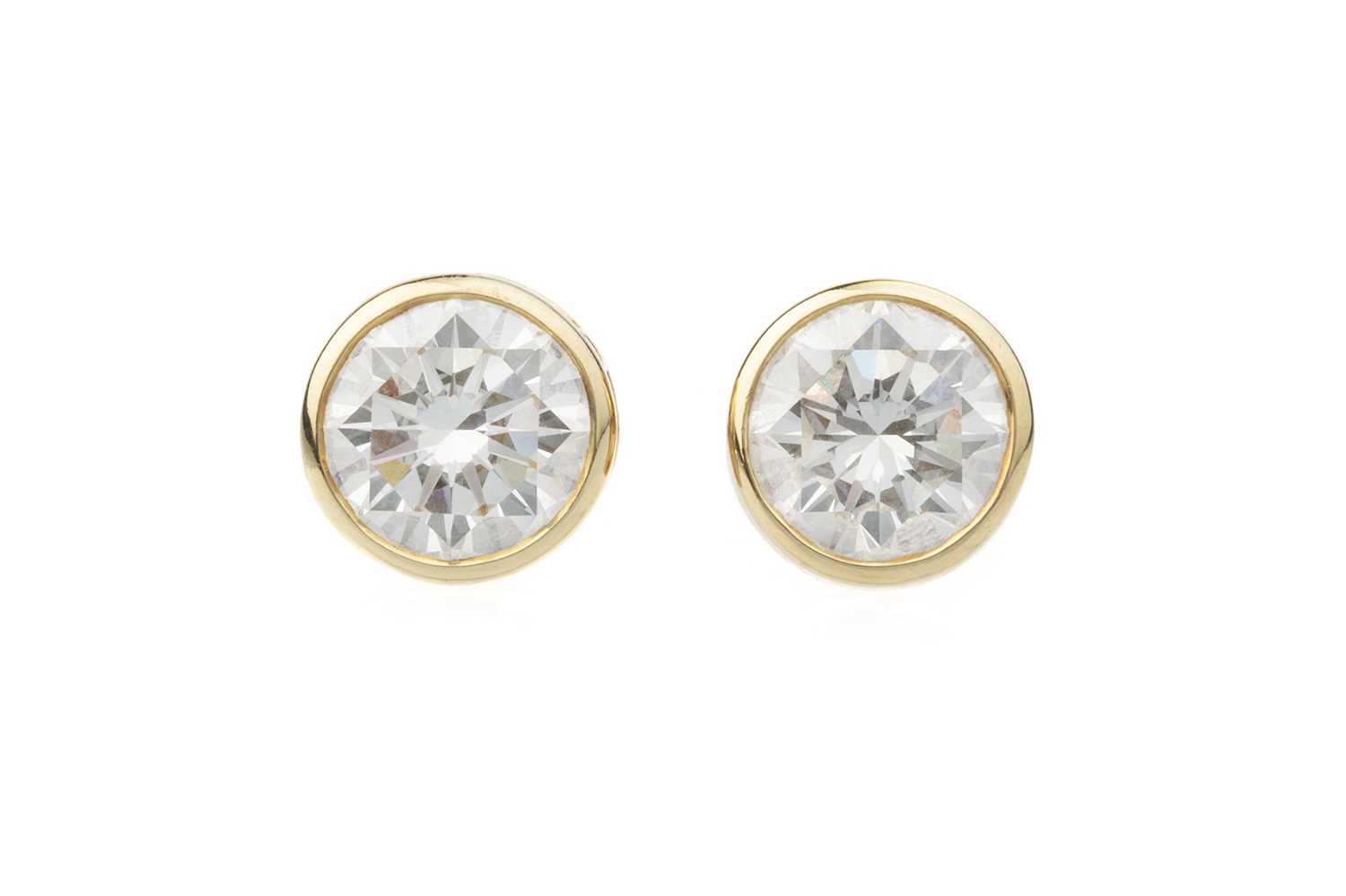 Lot 154 - A pair of diamond single stone ear studs by...