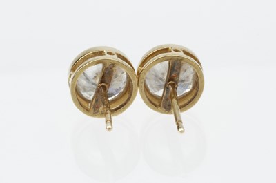 Lot 154 - A pair of diamond single stone ear studs by...