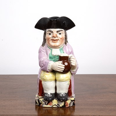 Lot 230 - Creamware toby jug 19th Century, with a...