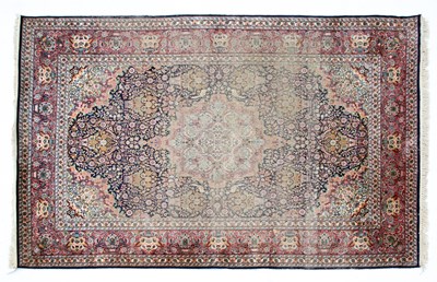 Lot 1051 - An Indian blue and red ground part silk rug