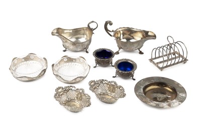 Lot 630 - A silver sauce boat, with scroll handle, on...