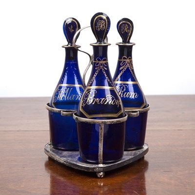 Lot 289 - Set of three Bristol blue decanters on silver...