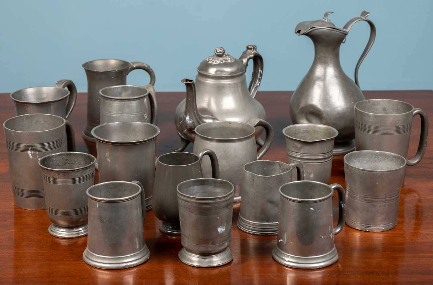 Lot 216 - An assortment of pewter tankards and jugs,...