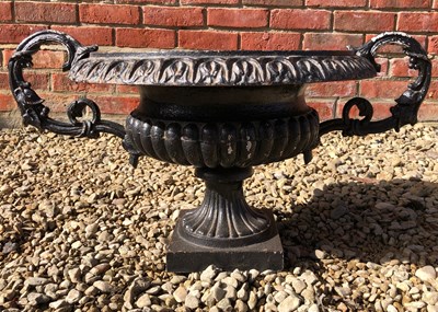 Lot 1224 - A small black painted cast iron shallow campana urn