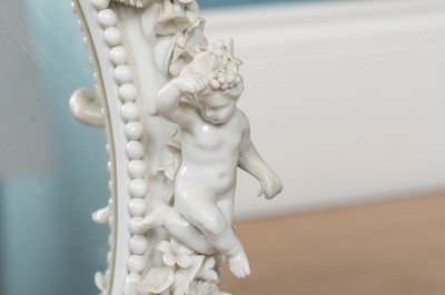Lot 543 - A Dresden porcelain framed oval mirror on an adjustable tripod stand