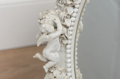 Lot 543 - A Dresden porcelain framed oval mirror on an adjustable tripod stand