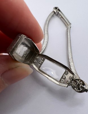 Lot 119 - A diamond set cocktail watch by Longines, the...