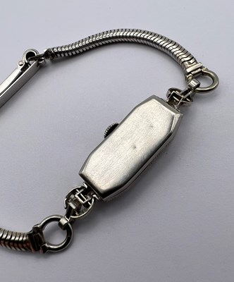 Lot 119 - A diamond set cocktail watch by Longines, the...
