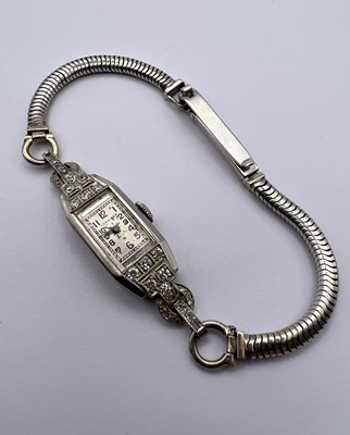 Lot 119 - A diamond set cocktail watch by Longines, the...