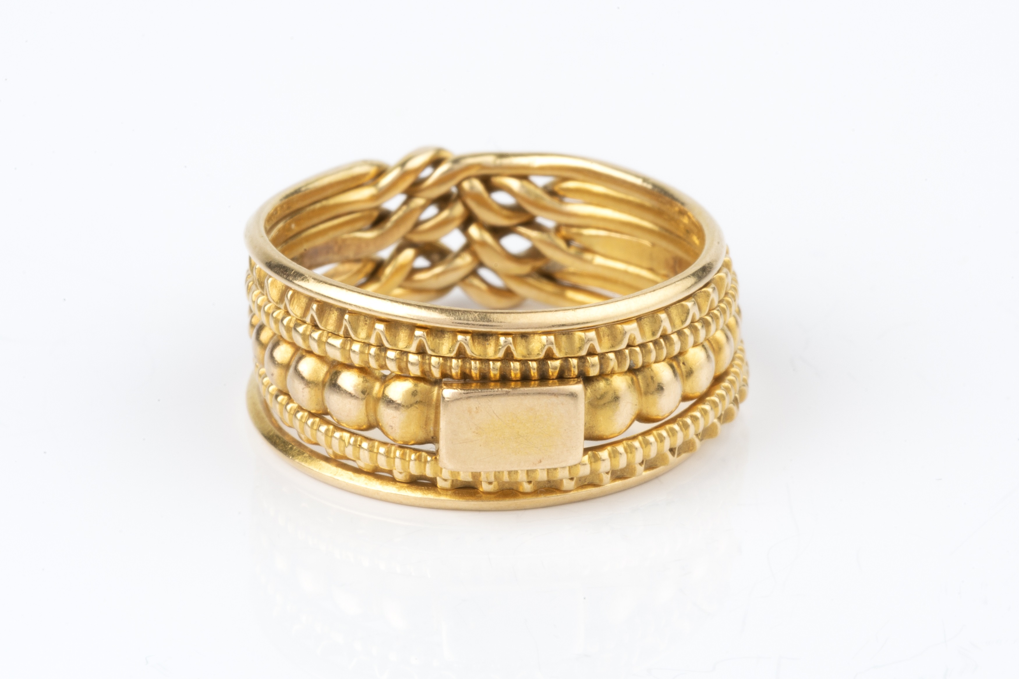 Lot 11 A puzzle ring, designed as seven entwined