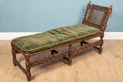 Lot 136 - A Carolean style carved oak daybed, with...