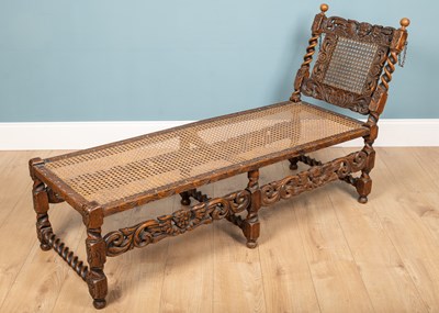 Lot 136 - A Carolean style carved oak daybed, with...